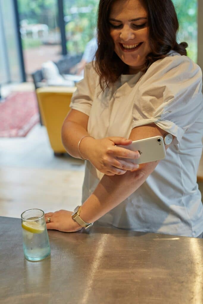 Person scanning a continuous glucose monitor on their arm at Integria Precision Medicine
