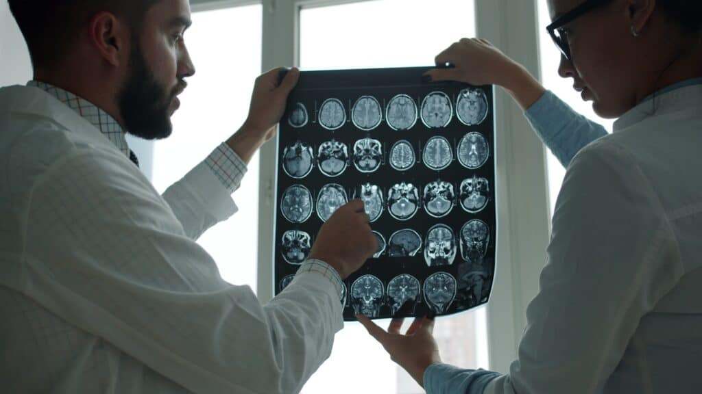 Physicians reviewing a brain MRI scan for MR Brain with MR Angiography at Integria Precision Medicine