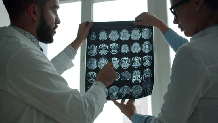 Physicians reviewing a brain MRI scan for MR Brain with MR Angiography at Integria Precision Medicine
