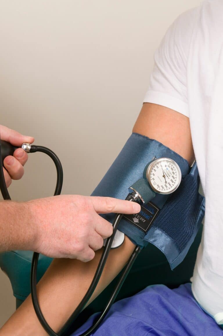 Clinician taking a patient's blood pressure during a vitals assessment at Integria Precision Medicine